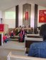 Pastor Cook prays with children at the Installation Service in May